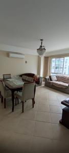 a living room with a table and a couch at Apartamento Balneário Camboriu in Balneário Camboriú