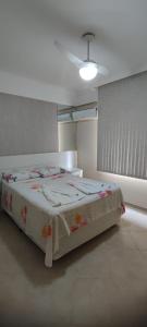 a bedroom with a large bed with a blanket on it at Apartamento Balneário Camboriu in Balneário Camboriú