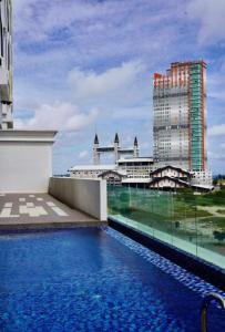 a swimming pool on the roof of a building at Alaghapoo Service Apartment Near Drawbridge in Kuala Terengganu