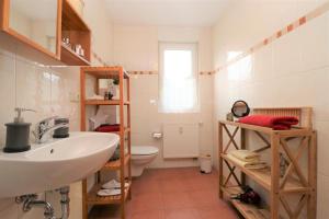 a bathroom with a sink and a toilet at "Strandkoje" Strandkoje, App 07 in Neuhaus +4 photos