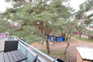 a balcony with a wooden bench and a playground at "Strandkoje" Strandkoje, App 07 in Neuhaus