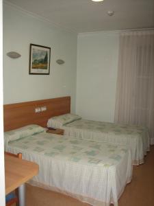 Posteľ alebo postele v izbe v ubytovaní Hostal Madruga