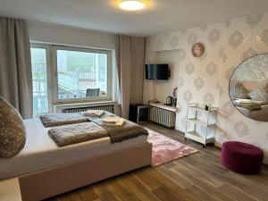 a bedroom with a large bed and a large window at Hotel Gonzlay in Traben-Trarbach
