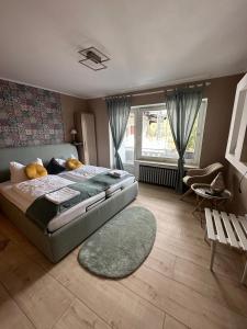 a bedroom with a large bed and a rug at Hotel Gonzlay in Traben-Trarbach