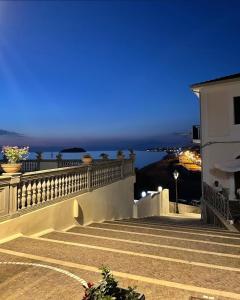 a set of stairs leading to a balcony at night at HomeSuite22 in Diamante