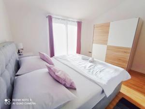 two twin beds in a room with a window at Apartman Mia with pool1 in Split