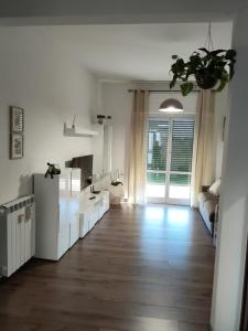 a white bathroom with a sink and a mirror at Casa Vacanze Celine a due passi dal mare in Savona