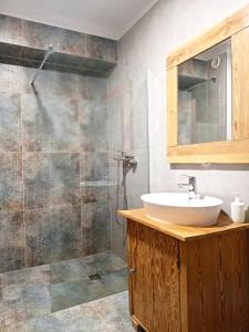 a bathroom with a sink and a shower at Rybacki Domek 50 metrów do morza! in Dziwnów