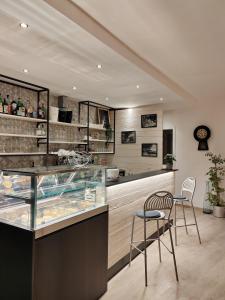 a restaurant with two chairs and a counter with food at Hotel Luisa in Brenzone sul Garda