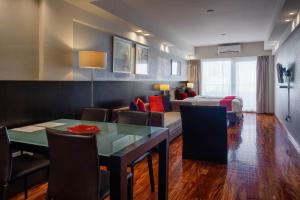 a living room with a bed and a dining room at Urban Suites Recoleta Boutique Hotel in Buenos Aires