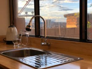 a kitchen sink with a window with a view at Monoambiente con vista panorámica in Sucre