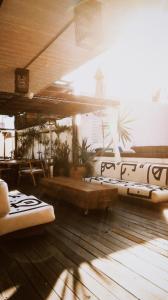 a room with two beds on a wooden floor at Hotel Sin Nombre in Oaxaca City