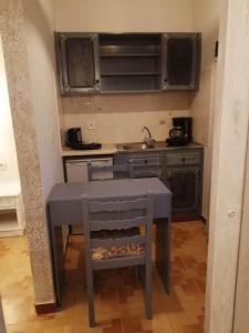 a small kitchen with a table and a sink at Dionisia Apartments 2 in Kefalos