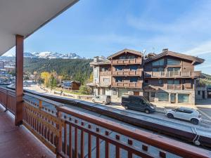 a balcony of a building with cars parked on a street at Studio Courchevel 1650, 2 pièces, 4 personnes - FR-1-563-117 in Courchevel