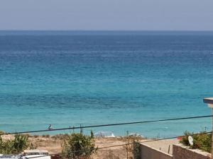 a view of the ocean from the balcony of a house at La villa de la mer in Sidi Bou Jobline