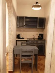a small kitchen with a table and a sink at Dionisia apartments 8 in Kos