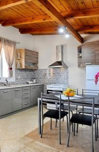 a kitchen with a table and chairs in a room at Irene home in Vlikhón