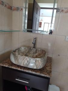 bagno con lavabo in marmo e specchio di Butterfly a Tajo Alto