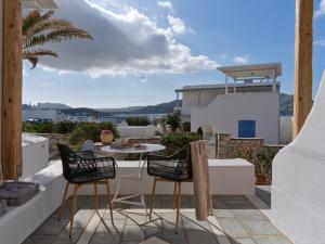 patio con mesa y sillas en el balcón en Ariti Seaside Residence en Náousa