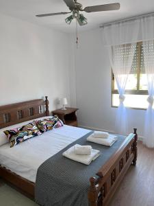 a bedroom with a bed with two towels on it at Garay Apartments in Benidorm