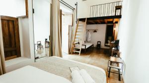 a bedroom with a bed and a staircase in a room at Hotel Sin Nombre in Oaxaca City