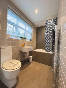 a bathroom with a toilet and a sink and a tub at Chester City-Walls Overlooking River (Central Location) in Chester