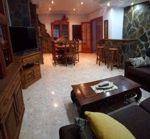 a living room with a couch and a table at casa con piscina privada in Vinarós