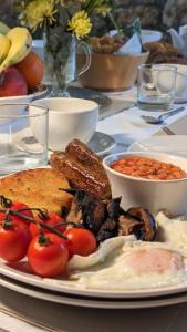 a plate of food on a table with tomatoes and bread at Britannia House Vintage B&B Cornwall in Helston