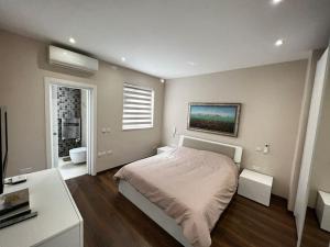 1 Schlafzimmer mit einem Bett und einem Bad in der Unterkunft Marsaxlokk SeaView 2 Bedroom Penthouse in Marsaxlokk