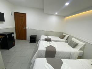 Postel nebo postele na pokoji v ubytování Hotel Caiçara