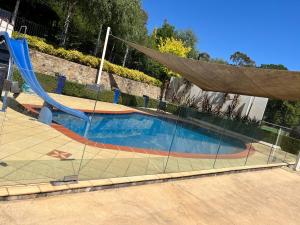 a swimming pool with a slide and a net at Studio at the Back of Mount Taylor in Lyons