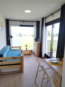 a bedroom with a bed and a large window at Anam Cara House in Serantes