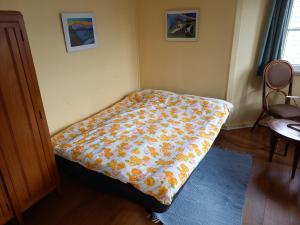 a bed in a room with a blanket on it at Ferienhaus mit Garten in CH 6616 Losone Tessin Casa Sabina in Losone +13 photos
