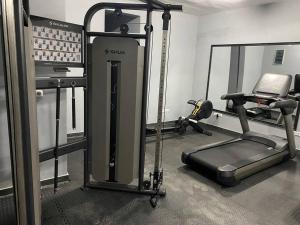 a room with a gym with a treadmill and a simulator at Luxurious Studios in Douala