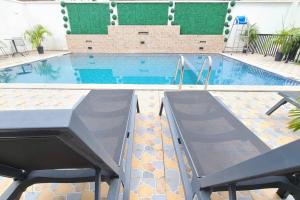 a large swimming pool with a ramp in a building at Luxurious Studios in Douala
