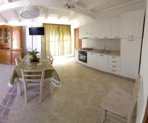 a kitchen with a table and chairs in a room at Case Pescatori Villette in Lampedusa