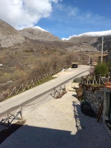 a road with a car driving down a mountain road at La Locanda n'gima all' ara in Aielli