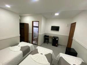 TV a/nebo společenská místnost v ubytování Hotel Caiçara