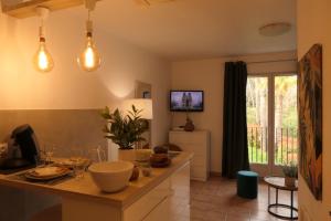 a kitchen with a counter with lights on it at Studio meublé en face du golf côté piscine in Mouans-Sartoux