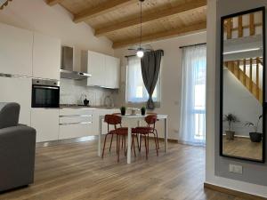 a kitchen and dining room with a table and chairs at LA FORMICA APARTMENT in Agrigento