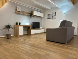 a living room with a couch and a television at LA FORMICA APARTMENT in Agrigento