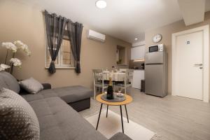 a living room with a couch and a table at Apartments Neptun in Baška