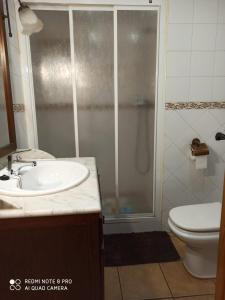 een badkamer met een douche, een wastafel en een toilet bij Casa Miriam II in Arroyo Frio