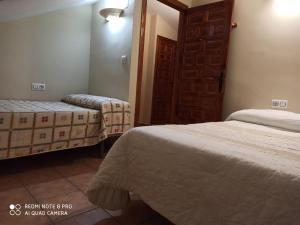 una camera d'albergo con due letti e una porta di Casa Miriam II ad Arroyo Frio
