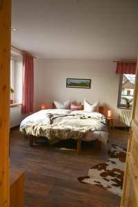 a bedroom with a large bed in a room at Fewo Pöhlbergblick Wolkenstein in Wolkenstein