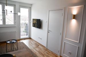 an empty living room with a door and a table at CROWN apartment in Subotica