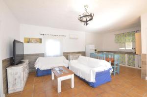 a room with two beds and a table in it at Casa Samuel Mayorazgo con piscina compartida in Cádiz