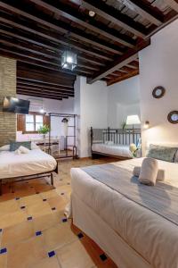 Posteľ alebo postele v izbe v ubytovaní SUITES CASA DE LAS COLUMNAS