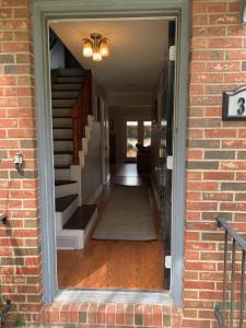 a hallway of a home with stairs and a brick wall at Creek View Townhome in Augusta