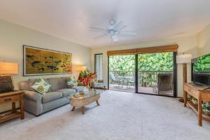 a living room with a couch and a table at Waikomo Streams 121 in Koloa